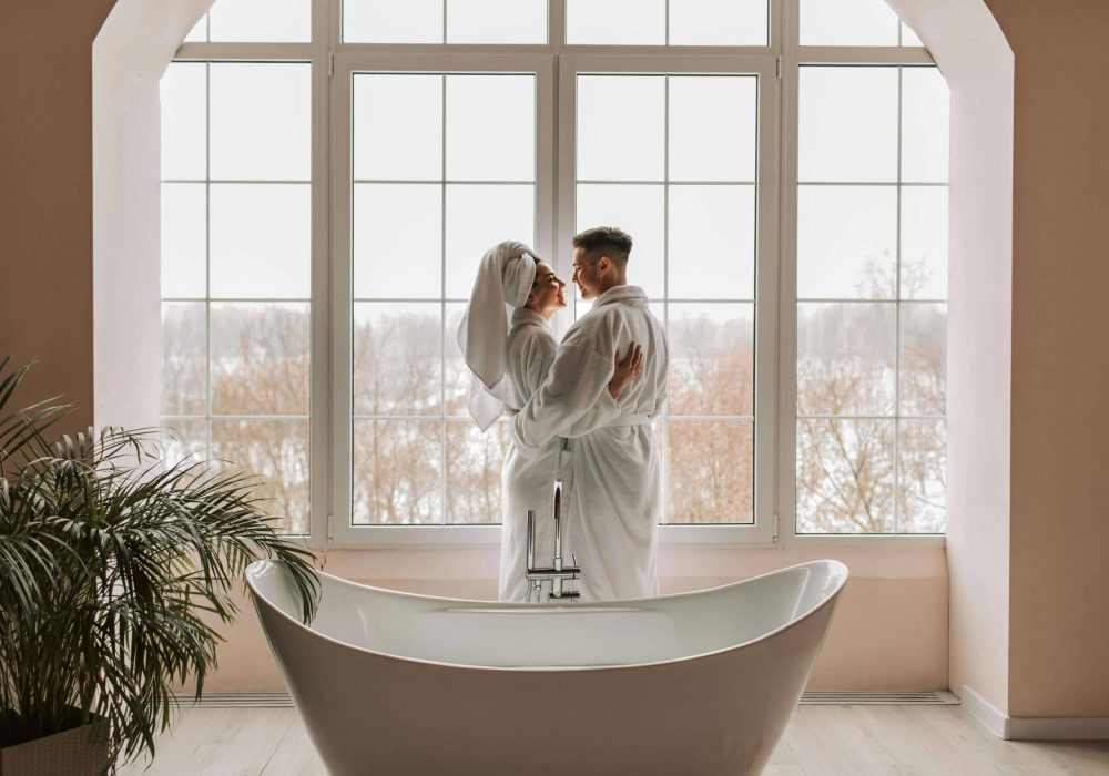 a couple hugging and a bathtub